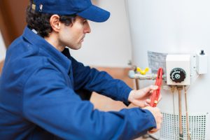 Plumber Fixing Hot Water Heater